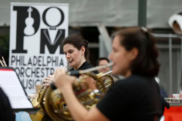 Bryn Coveney, a student at the Curtis Institute of Music, plays with members of the Philadelphia Orchestra outside 30th Street Station, one of several concerts by orchestra musicians throughout the Philadelphia area.