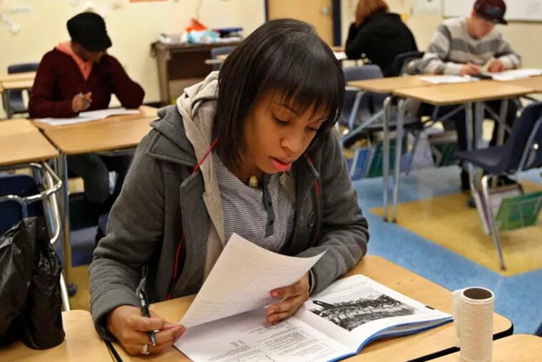 Samantha Mondesir takes the social studies part of the GED at the Harambee charter school. Many students have rushed to take the test before it is replaced.