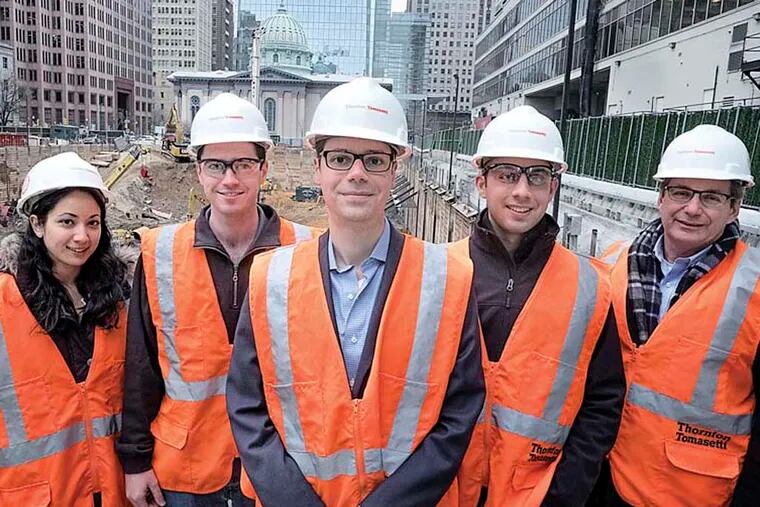 December 5, 2014 Bob Fernandez writes about Andrew Blasetti , a 32 year Villanova grad who is leading a team of young structural engineers designing the structure that will become the new Comcast tower. Blasetti is an Associate at the engineering firm of Thornton Tomasetti. Here, Blasetti, center and his team including the director of the project and firm VP Mark Coggin, right at the construction site for the new cComcast Tower . Left to right, Angela Heinze, Stephane Kane, Andrew Blasetti, Louis Ross and Mark Coggin.  (ED HILLE / staff photographer )