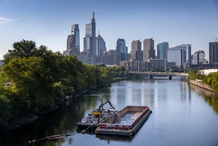 Texas-based Dredgit is pumping the muck from north side of Schuylkill river and loading onto a barge below Spring Garden Bridge over the river on Tuesday morning August 9, 2022.