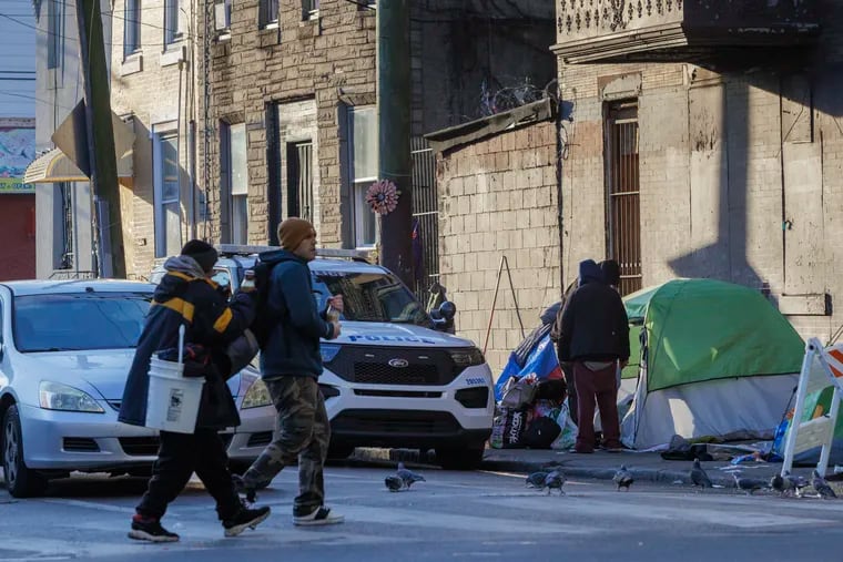 Philadelphia police along Kensington and E. Orleans Street moving people off the sidewalk on Jan. 3. Philadelphia Council members are seeking a triage center where police can take people to divert them into treatment.