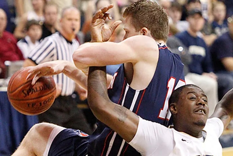 Pitts' Dante Taylor and Penn's Andreas Schreiber battle for a rebound during the second half. (AP Photo/Keith Srakocic)