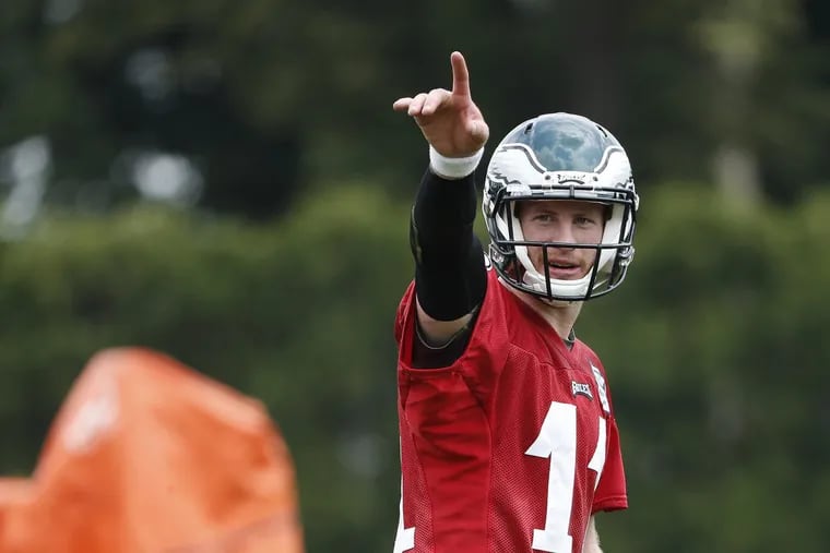 Carson Wentz directs a receiver during Eagles minicamp in June.