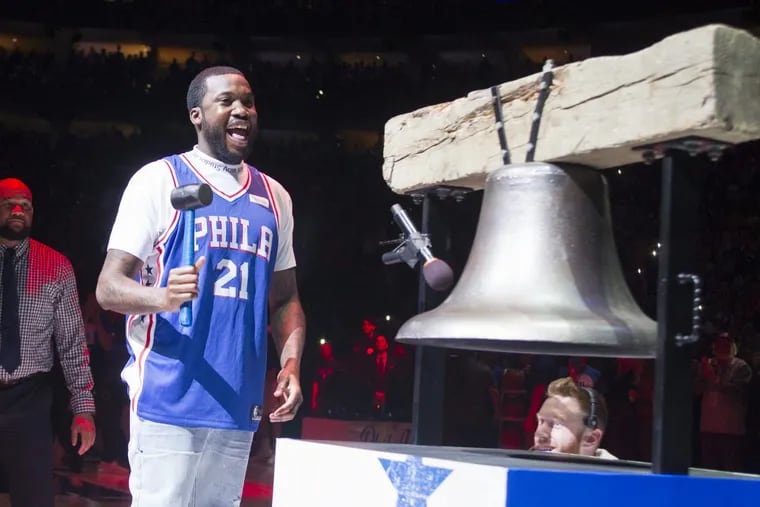 Rapper Meek Mill rings the Liberty Bell replica before the playoff game between the Sixers and the Heat at the Wells Fargo Center on Tuesday. Mill, who has been incarcerated since November, was released on bail.