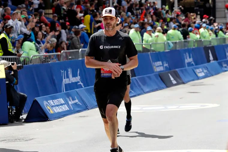 NASCAR driver Jimmie Johnson finishes the 123rd Boston Marathon on April 15.
