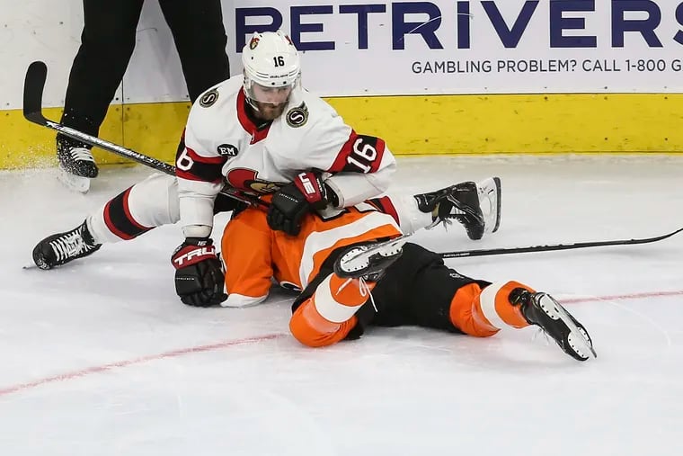 Flyers Travis Konecny is slashed by Senators Austin Watson during the third period at the Wells Fargo Center in Philadelphia, Friday, April 29, 2022.  Senators beat the Flyers 4-2.