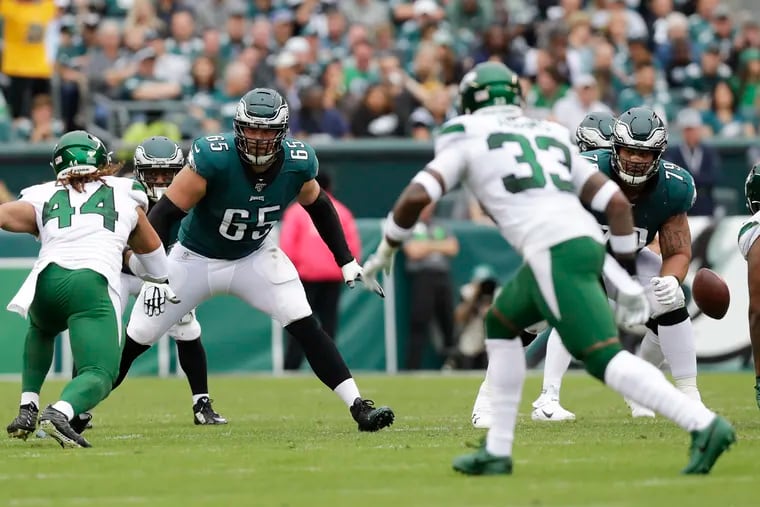 Eagles offensive linemen Lane Johnson and Brandon Brooks watch New York Jets linebacker Harvey Langi (left) and strong safety Jamal Adams (33) during Sunday's game.
