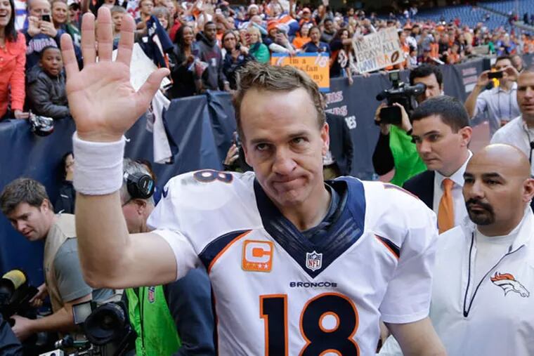 The Broncos' Peyton Manning (18) waves to fans following an NFL football game against the Houston Texans, Sunday, Dec. 22, 2013, in Houston. Manning threw his 51st touchdown pass of the season to set a new NFL record. (David J. Phillip/AP)