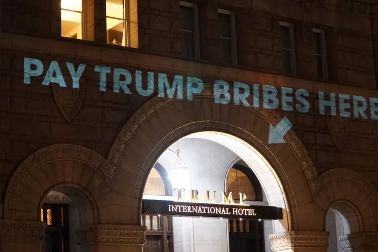 “Pay Trump Bribes Here” is projected onto a wall of the Trump International Hotel in Washington, on May 15, 2017.