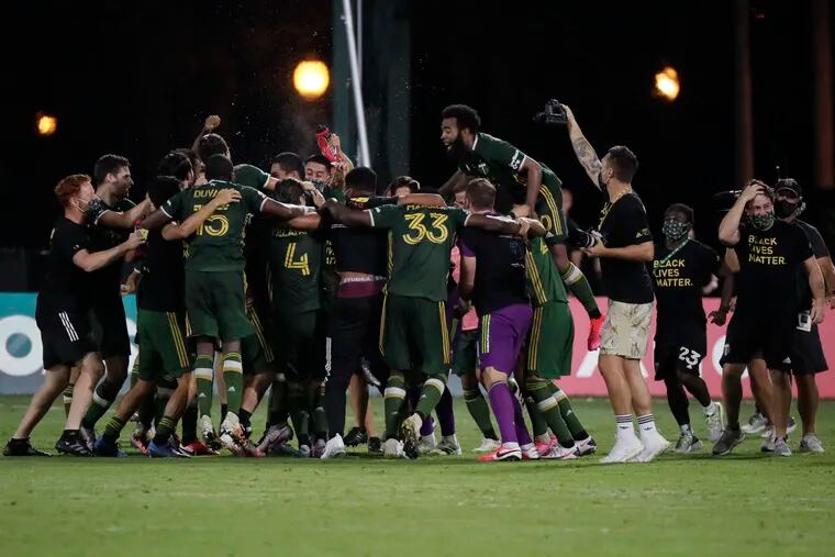 Portland Timbers players celebrating after the final whistle.