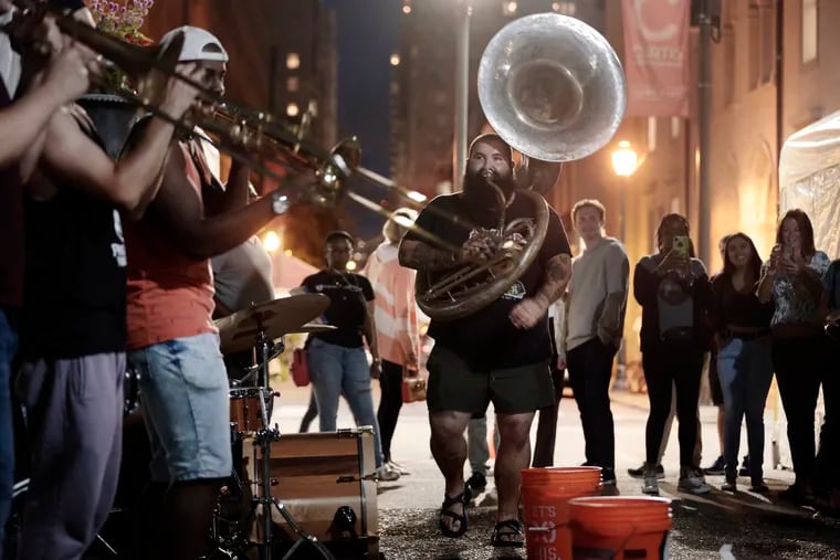 Sousaphone player Sam Gellerstein and the rest of Snacktime perform in Rittenhouse Square.
