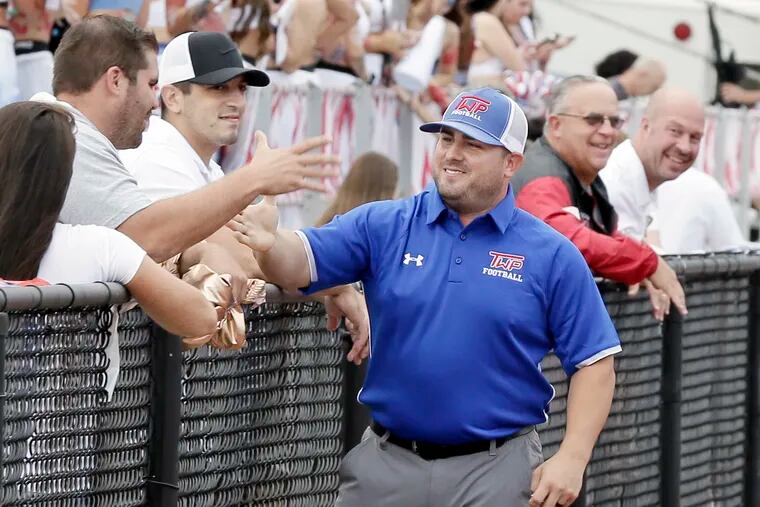 New Washington Township football coach Mike Schatzman greets friends and fans before Friday's game that was eventually postponed to Saturday due to lightning.