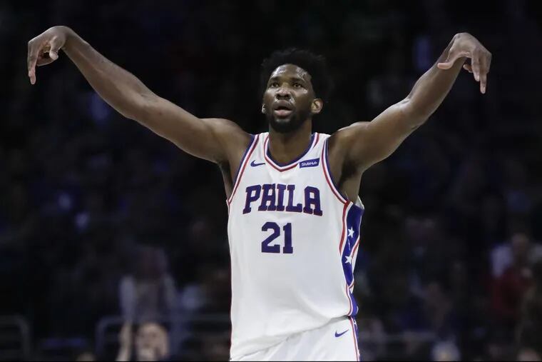 Sixers center Joel Embiid celebrates after making a second-quarter three against the Milwaukee Bucks in Saturday’s 116-94 win.