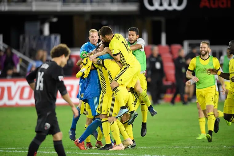 Columbus Crew goalkeeper Zack Steffen is swarmed by teammates after the Crew beat D.C. United in a penalty shootout in the first round of the MLS playoffs.