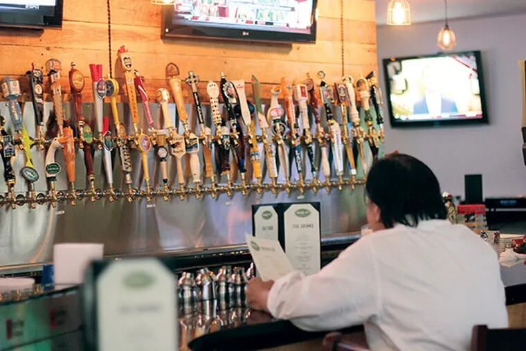 BarLy, a sports bar, offers an astonishing 60 beers on tap in Chinatown. ( MICHAEL KLEIN / Staff )