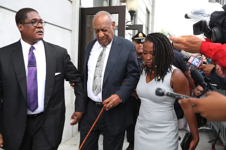 Bill Cosby leaves the Montgomery County Courthouse  with his spokesman, Andrew Wyatt (left), after a mistrial was declared on Saturday. (David Swanson/ Staff Photographer)