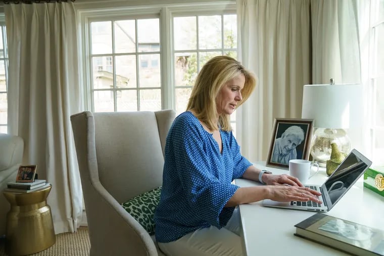 Liz Duffy, in her St. Davids home, posted on Facebook to let people know about the death of her father (pictured on her desk). Later she realized there were still many people who didn't know.
