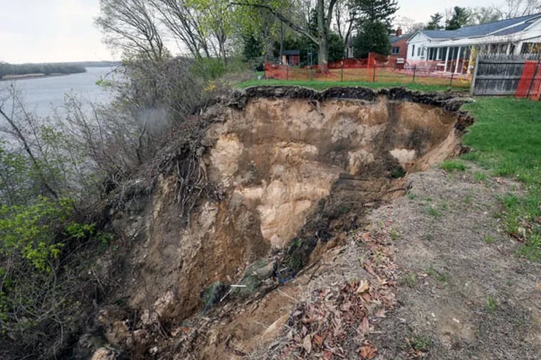 Much of the backyards of two houses in the 500 block of East Front Street in Florence collapsed. The homes were declared unsafe and the residents were urged to leave. An overflowing storm drain may be to blame. (STEVEN M. FALK / Staff Photographer)