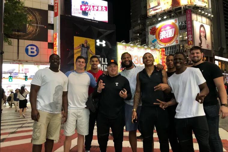 Temple football players and coach Geoff Collins in Japan