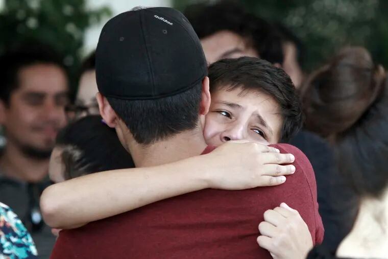 Youths comfort each other at the funeral of elementary school principal Elsa Mendoza, of one of the 22 people killed in a shooting at a Walmart in El Paso, in Ciudad Juarez, Mexico, Thursday, Aug. 8, 2019. Mexican officials have said eight of the people killed in Saturday's attack were Mexican nationals.