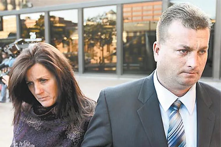 Former tug pilot Matthew Devlin and his wife, Corinne, of Catskill, N.Y., leaving the U.S. Courthouse in Philadelphia. Distracted by calls over their son’s oxygen deprivation during eye surgery, Devlin piloted a barge over a duck boat stalled in the Delaware River, killing two Hungarian students. (Matt Rourke/AP)