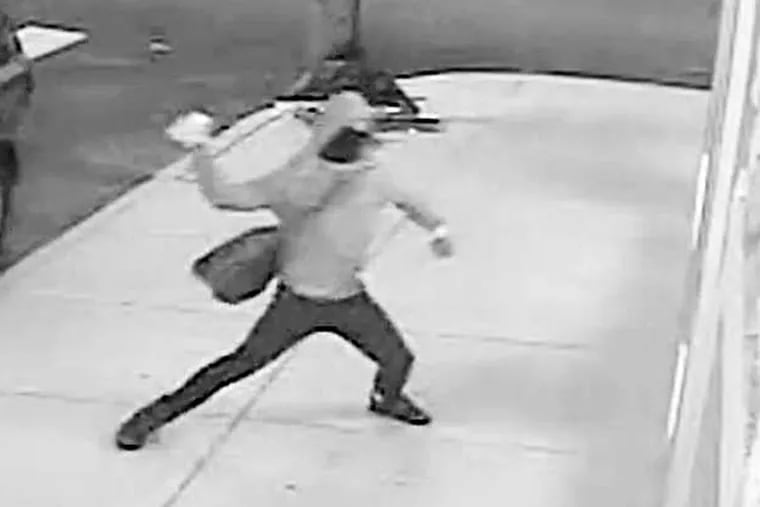 A masked vandal, seen here on surveillance footage, caused $2,000 worth of damage to developer Ori Feibush's Point Breeze coffee shop on Saturday morning, an attack Feibush claims was motivated by a local committee that opposes his building projects in the area. The group denies any involvement in the incident.