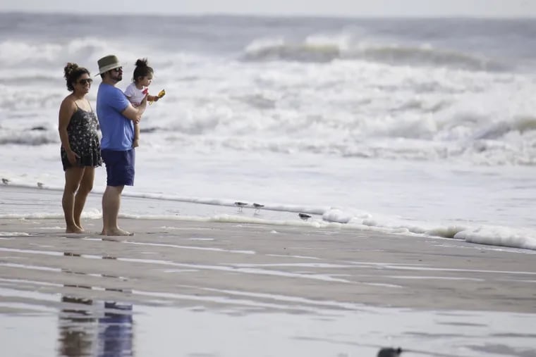 In Stone Harbor, Carmen (left) and Chris Hoffert of Lancaster, Pa. helped daughter Wren Hoffert discover the beach and Tropical Storm Hermine for the first time on September 4, 2016.