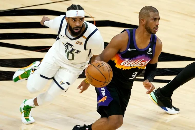 Phoenix Suns guard Chris Paul drives as Utah Jazz guard Mike Conley pursues.