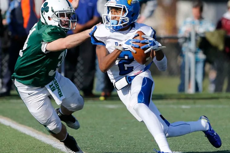 Lonnie Moore of Paul VI runs past Camden Catholic's Jeremy Nutt on Nov. 26. Separating non-public schools could negatively impact football programs in the smaller schools like Paul VI. CHARLES FOX / Staff