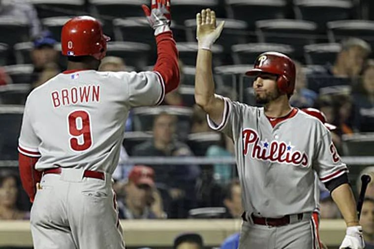 Kevin Frandsen greets Domonic Brown after Brown's solo home run against the Mets on Monday. (Kathy Willens/AP)