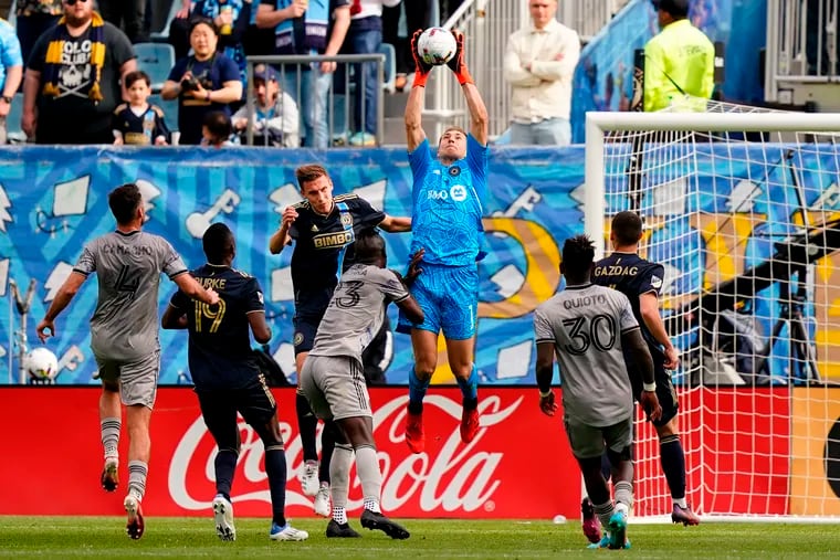 Montreal goalkeeper Sebastian Breza (center) leaps to grab the ball during the second half.
