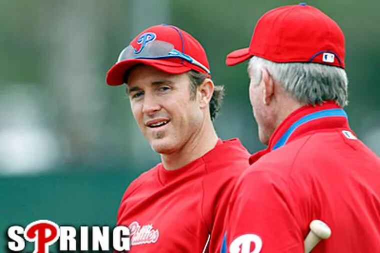 Chase Utley speaks with Mike Schmidt at the Phillies workout on Monday. (Yong Kim/Staff Photographer)