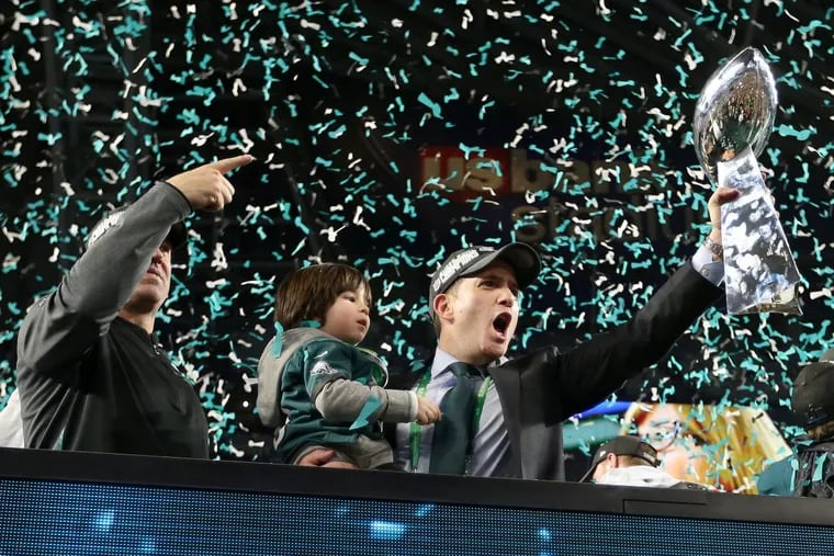 Eagles vice president Howie Roseman shouts while holding the Lombardi Trophy after Super Bowl LII, at U.S. Bank Stadium in Minneapolis.