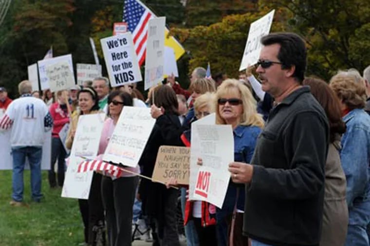 Protesters stage a rally outside of B. Bernice Young Elementary School for concerns over an Internet video showing students singing praise for President Obama, Monday, Oct. 12, 2009 in Burlington Township. (AP Photo/Camden Courier-Post, Douglas M. Bovitt)