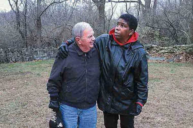 David Bartholomew, a direct descendant of abolitionists Thomas and Hannah Atkinson, stands in the Upper Dublin Quaker Meeting graveyard, along with Meeting member Avis Wanda McClinton, who was instrumental in submitting a proposal for a historical marker. Behind them is the unmarked gravesite for an unknown number of fugitive slaves.
Photo by Annette John-Hall/Staff