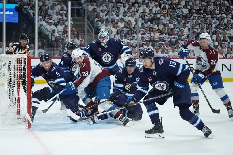 Gabriel Vilardi #13 of the Winnipeg Jets tries to keep the puck away from the Colorado Avalanche in Game Two of the First Round of the 2024 Stanley Cup Playoffs at Canada Life Centre on April 23, 2024, in Winnipeg, Canada.