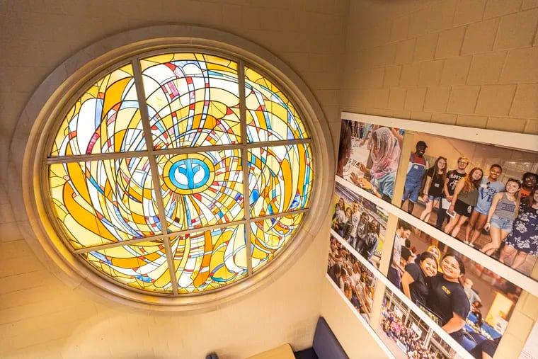 A stained glass window with an old Cabrini University logo in the center can be seen at the George D. Widener Campus Center at Cabrini University in Radnor. The university will close its doors in June after 67 years.