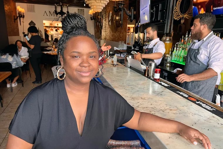Felicia Wilson, owner of Amina, 104 Chestnut St., at the bar in May 2023.