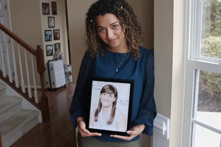 Trinity Jagdeo, 23, holds a 1970s era Pemberton High School photo of Roberta Anne Michels-Hopkins, her grandmother who went missing in 1981.