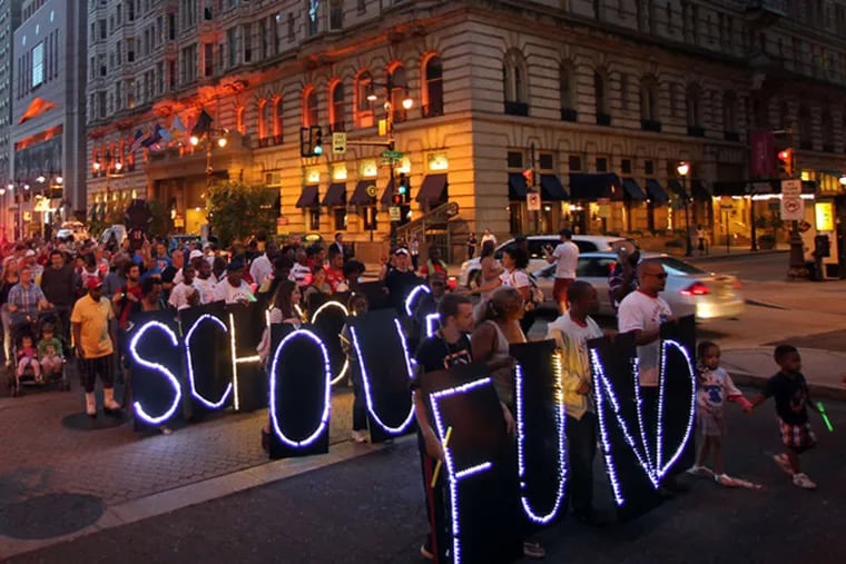 Protesters marching against education cuts on Broad Street in October. The protest began as a candlelight vigil at Gov. Corbett's Philadelphia office.