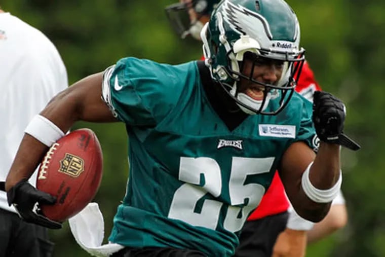 LeSean McCoy runs with the ball curing the Eagles' first day of OTAs.  (AP Photo/Alex Brandon)