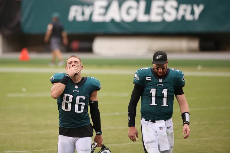Eagles tight end Zach Ertz (86) and quarterback Carson Wentz (11) walk off the field after Sunday's 23-23 tie against the Cincinnati Bengals.