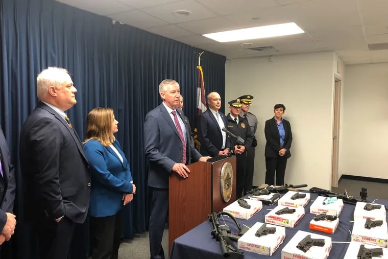 Montgomery County District Attorney Kevin Steele (center) announced the arrests of eight members of a gun-trafficking ring that prosecutors say purchased nearly 100 guns.