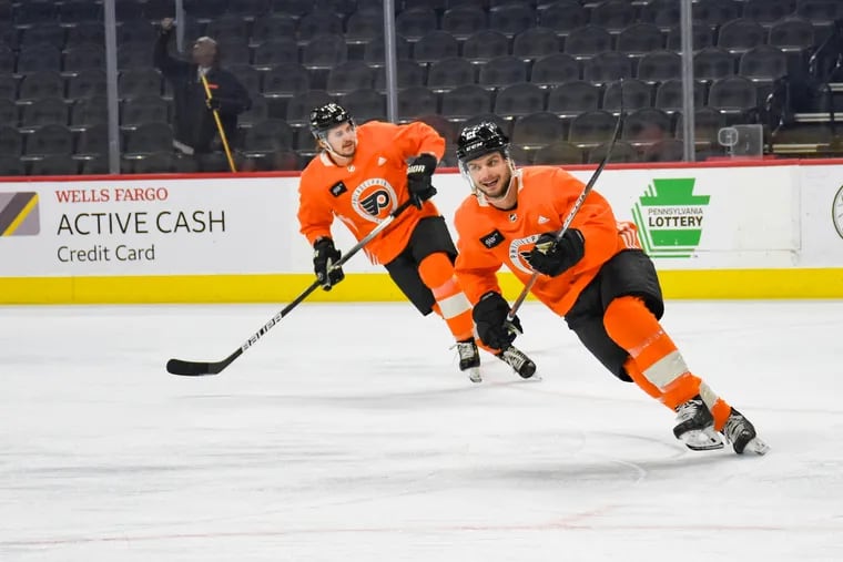 Travis Konecny (11) and Scott Laughton (21) skate in a drill during Flyers morning skate ahead of their home game against the Columbus Blue Jackets on Tuesday, April 5, 2022. It is Laughton's first game since his concussion.