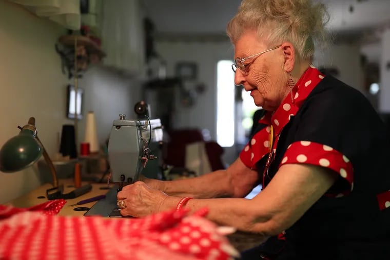 Mae Krier, 94, was a riveter for Boeing during World War II. Krier sews "Rosie the Riveter" bandannas at her home in Levittown, Pa.