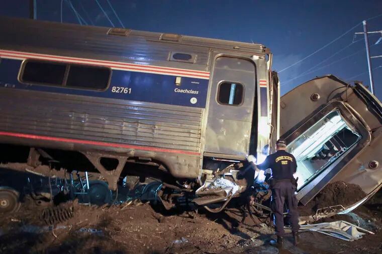 Emergency crews at the May derailment in Philadelphia. Experts have said positive train control would have prevented the disaster. Railroads want more time. JOSEPH KACZMAREK / File Photo