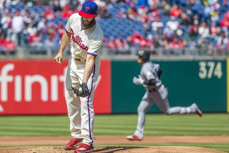 Phillies’ pitcher Jake Arrieta gets a new baseball after Marlin’s infielder Miguel Rojas homered off the Phillies’ ace in the first inning of Arrieta’s debut.