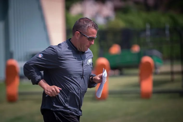 Eagles quarterbacks coach John DeFilippo takes the field at practice in June.
