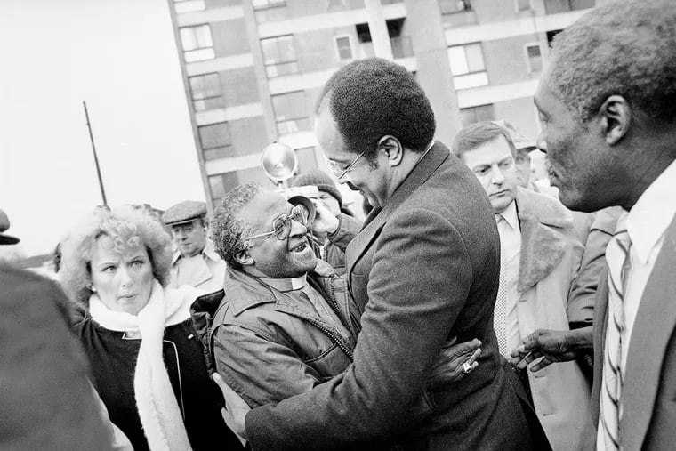 Bishop Desmond Tutu, left, is greeted by Rep. William H. Gray III, who just returned from a trip to South Africa, outside Philadelphia's Bright Hope Baptist Church, Jan. 14, 1986. Tutu attended a breakfast there sponsored by the Black Clergy of Philadelphia and Vicinity, the Jewish Community Relations Council of Greater Philadelphia and the Board of Rabbis of Greater Philadelphia. (AP Photo/Peter Morgan)