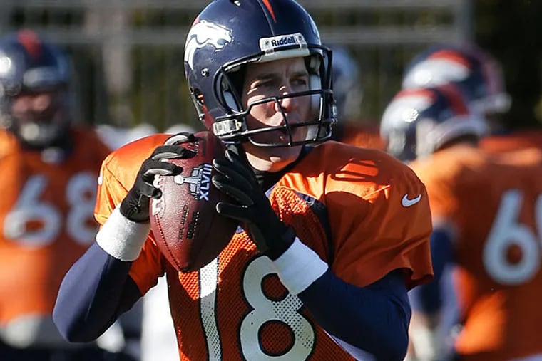 Broncos quarterback Peyton Manning (18) passes during practice Wednesday, Jan. 29, 2014, in Florham Park, N.J. The Broncos are scheduled to play the Seattle Seahawks in the NFL Super Bowl XLVIII football game Sunday, Feb. 2, in East Rutherford, N.J. (Mark Humphrey/AP)